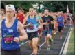  ?? PAUL DICICCO — THE NEWS-HERALD ?? Runners at the start of the Friday Night Lights 5K race on July 13 at Mentor’s Jerome T. Osborne Stadium.