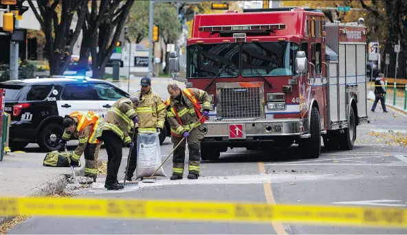  ?? PHOTOS: JASON FRANSON/THE CANADIAN PRESS ?? Crews clean up the scene on Sunday where a cube van ran into pedestrian­s and later flipped over while being pursued by police Saturday.