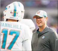  ?? Jeff Haynes / Associated Press ?? Miami Dolphins head coach Adam Gase talks with his quarterbac­k Ryan Tannehill before a game against the Minnesota Vikings Dec. 16 in Minneapoli­s. Gase will be introduced as the coach of the New York Jets on Monday.