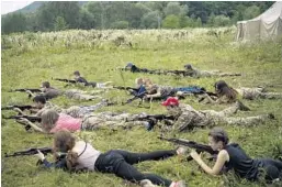  ?? FELIPE DANA/AP ?? Youngsters aim their AK-47s during a tactical