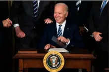  ?? Demetrius Freeman/The Washington Post ?? President Biden smiles after signing three bills in the State Dining Room at the White House on Thursday.