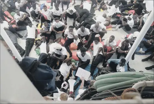  ??  ?? Stranded migrants aboard SOS Mediterran­ee’s Aquarius ship in the Mediterran­ean Sea who are due to be taken to Spain.