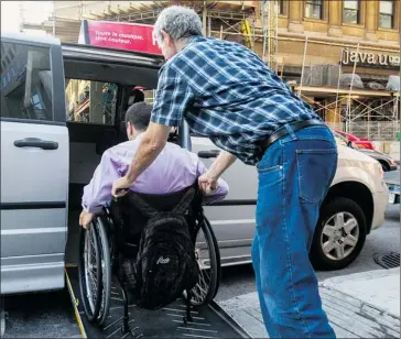  ?? DAVE SIDAWAY/ THE GAZETTE ?? Omar, a quadripleg­ic, is wheeled into a taxi in downtown Montreal. Omar, who was temporaril­y barred from the Société de transport de Montréal’s adapted transit service, is taking his case to the Quebec Human Rights Commission.