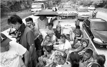  ??  ?? Residents fleeing from Marawi city are cramped on a truck as they traverse a traffic gridlock near a police checkpoint at the entrance of Iligan City, in southern island of Mindanao. — AFP photo