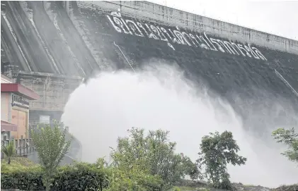  ?? CHANAT KATANYU ?? Mist shrouds the rear of the Khun Dan Prakan Chon dam in Nakhon Nayok’s Pak Phli district, where excess water is discharged. Yesterday, the dam held about 163 million cubic metres of water, about 73% of its capacity.