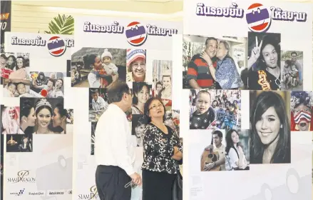  ??  ?? In this 2010 file photo, visitors view an exhibition, ‘Siam, Land of Smiles’ presenting various expression­s of smiles at a Bangkok department store.