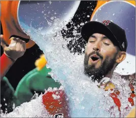  ?? Elise Amendola ?? The Associated Press Rick Porcello gets doused by two Red Sox teammates after pitching a one-hitter in Boston’s 4-1 win over the Yankees on Friday at Fenway Park. He struck out nine.