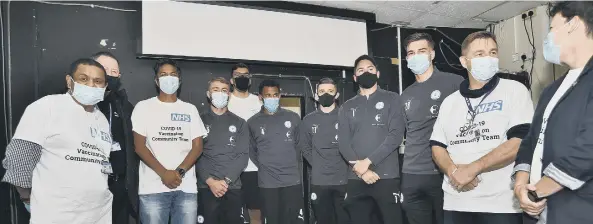  ??  ?? Posh players waiting for their jabs and, right, Kyle Barker being vaccinated. Pictures: David Lowndes