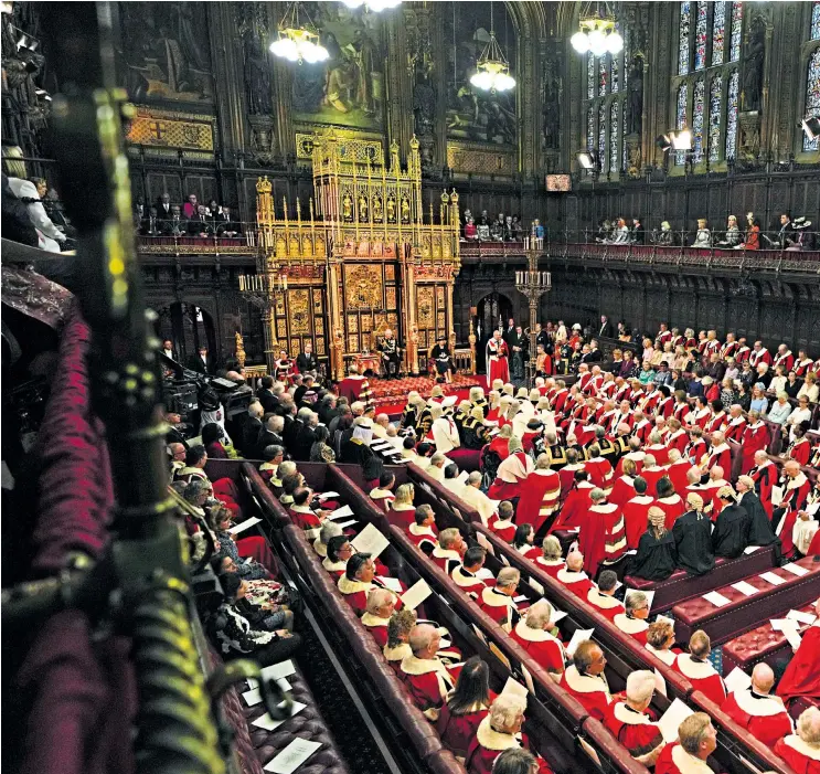  ?? ?? Clockwise from main: Prince Charles reads the Queen’s speech next to her crown; the crown is carried by David Cholmondel­ey; the Yeomen of the Guard in the Lords to check the cellars, led by a woman for the first time; the Household Cavalry ruffled by the wind outside the palace