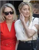  ??  ?? WINNERS: Amber Heard, right, embraced by her lawyer at court