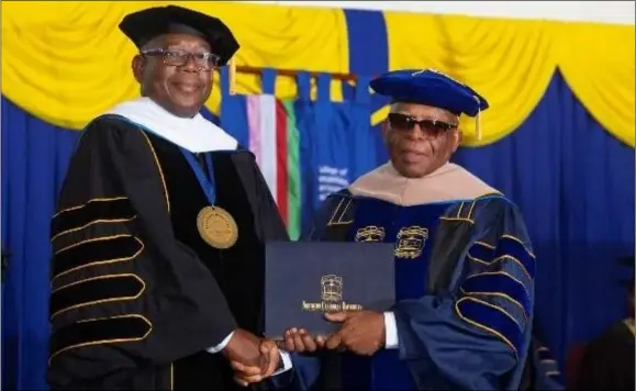  ?? ?? President Lincoln Edwards (left) confers the Honorary Doctor of Commerce degree to businessma­n and hotelier Dennis Morgan