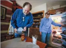  ??  ?? Rick Bragg, 58, left, pours sweet tea into a glass for his mother, Margaret Bragg, 81, right, , in Jacksonvil­le, Ala. Bragg’s mother Margaret is the subject of his latest book, “The Best Cook in the World.”