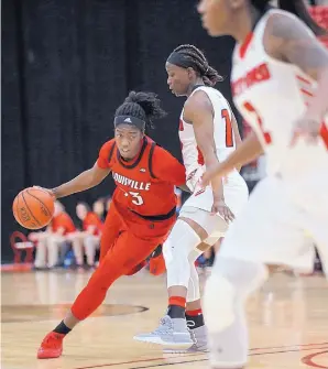  ?? CHASE STEVENS/ASSOCIATED PRESS ?? Louisville’s Jazmine Jones drives past Hartford’s Ella Awobajo, center, as Hawks teammate Sierra DaCosta looks to help. The Cardinals defeated Hartford 89-69 in the South Point Thanksgivi­ng Shootout in Las Vegas, Nev.