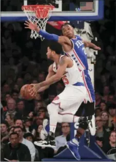  ?? JULIE JACOBSON — THE ASSOCIATED PRESS ?? Derrick Rose (25) attempts a reverse layup against Sixers’ Richaun Holmes Saturday in New York. the