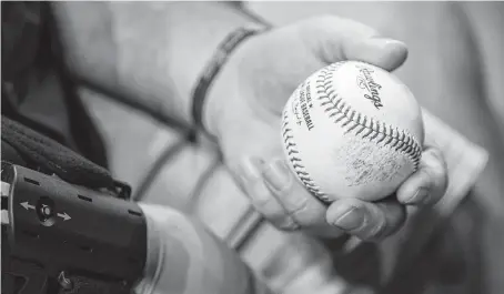  ?? Jon Shapley / Staff photograph­er ?? John Barnes, the Santa Fe ISD police officer who was injured in the mass shooting, threw the ceremonial first pitch before a game Sunday between the Astros and the Seattle Mariners in Houston.