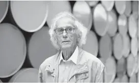  ?? VALERY HACHE/GETTY-AFP 2016 ?? Artist Christo poses in front of the monumental “Mastaba” artwork at the Fondation Maeght in France. Christo died Sunday at his home in New York. He was 84.