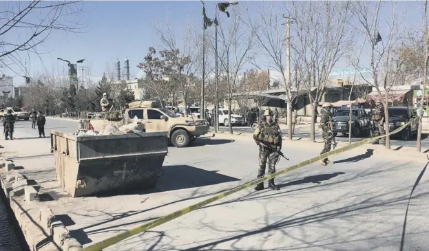  ?? PICTURE: SHAH MARAI/GETTY ?? 0 Afghan security forces stand guard near the site of multiple blasts in Kabul in which more than 40 died in an attack claimed by Islamic State