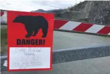  ??  ?? ANCHORAGE: A sign warns people that the trail head is closed after a fatal bear mauling at Bird Ridge Trail in Anchorage, Alaska.—AP