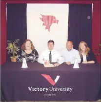  ??  ?? Taylor Pierce has signed to play baseball for the Victory University Eagles. Joining him for the signing ceremony are his parents, Cheri and Terry Pierce, and his sister, Sarah.