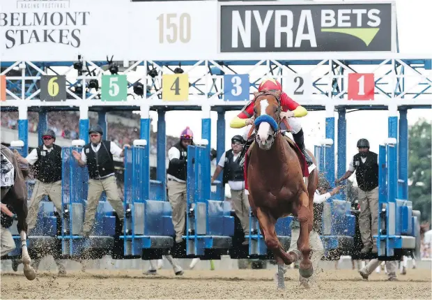  ?? — GETTY IMAGES FILES ?? Jockey Mike Smith rides Justify out of gate one at the 150th running of the Belmont Stakes Saturday in Elmont, N.Y. Justify, who was bred by Langley’s John and Tanya Gunther, becomes the 13th Triple Crown winner and the first since American Pharoah in...