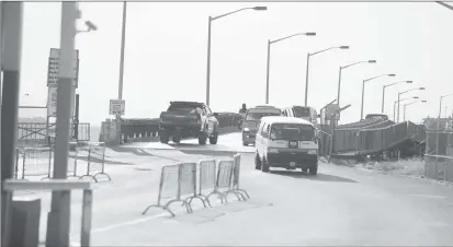  ??  ?? Vehicles moving across the bridge yesterday afternoon. (Photo by Terrence Thompson)