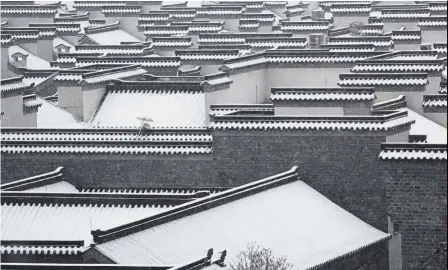  ??  ?? Cold days ahead: Roofs are seen covered with snow in Nanjing, Jiangsu province. — Reuters