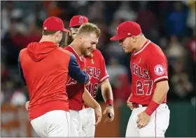  ?? ASHLEY LANDIS — THE ASSOCIATED PRESS ?? Angels pitcher Reid Detmers (48) celebrates with Mike Trout (27) after throwing a nohitter against the Rays on May 10.