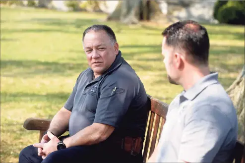  ?? H John Voorhees III / Hearst Connecticu­t Media ?? Detective John Kimball, left, Connecticu­t State Police Western District Major Crime, and Officer Thomas Patten, right, New Canaan Police Department, who is assigned to the investigat­ion devision, sit in Waveny Park and talk about the Dulos investigat­ion. Monday in New Canaan.