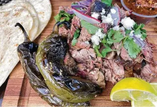  ?? Photos by Mike Sutter / Staff ?? The brisket barbacoa, which is rubbed with salt, pepper and garlic confit, then smoked and finished in banana leaves, marries the best of the two barbecue styles.