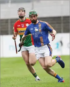  ??  ?? Wicklow’s John Henderson is action against Carlow.
