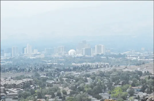  ?? The Associated Press ?? Scott Sonner
Smoke from California wildfires covers downtown Reno on Wednesday, obscuring the Sierra range that is typically visible to the west. “This is something that’s happening all the time now,” said Sen. Catherine Cortez Masto, D-Nev., at a recent roundtable.