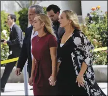  ?? Associated Press ?? SAD DAY — Carli Skaggs, center in burgundy dress, arrives with her family at St. Monica Catholic Church for a memorial for her husband, Los Angeles Angels pitcher Tyler Skaggs on Monday in Los Angeles.