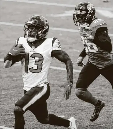  ?? Brett Coomer / Staff photograph­er ?? Texans wide receiver Brandin Cooks (13) turns on the jets in an October victory over the Jaguars, eluding safety JarrodWils­on for a 57-yard touchdown that was part of his eight-catch, 161-yard day.