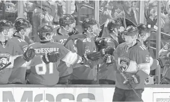  ?? JOEL AUERBACH/AP ?? Panthers center Aleksander Barkov, right, is congratula­ted by teammates after scoring a goal during the second period of Saturday’s game against the Chicago Blackhawks at BB&T Center in Sunrise.