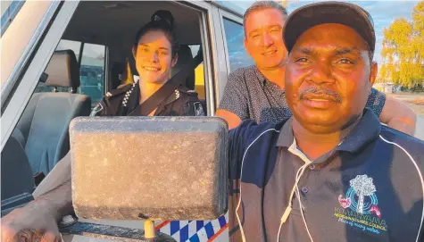  ?? ?? Police Constable Emily Dunell, Minister Craig Crawford and Kowanyama councillor and footy coach Jacob Josiah on community night patrol at sunset in Dump St at the Western Cape Aboriginal township.