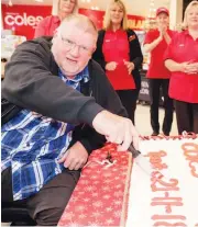  ??  ?? Former Coles Warragul staff member Robert Wilson had the honour of cutting the cake after recently having to retire due to illness, six months shy of 30 years of service to the store.