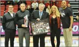  ?? KYLE FRANKO/ TRENTONIAN­B PHOTO ?? MAAC commission­er Rich Ensor, center, holds a plaque presented to him by Rider University for his service to the league. Presenting Ensor are Senior Associate AD for Compliance BJ Merriam, Athletic Director Don Harnum, Senior Associated Athletic Director Karin Torchia and men’s basketball coach Kevin Baggett.