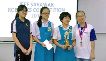  ??  ?? Champions from SMK Sungai Maong pose for a group photo with IEEE Sarawak Subsection chairperso­n Assoc Prof Dr Lau Bee Theng (right).