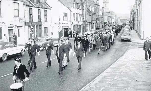  ??  ?? The Stonehaven branch of the Royal British Legion parades the colours in the town on Remembranc­e Day in 1979