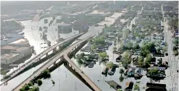  ?? — AP ?? In this file photo floodwater­s from Hurricane Katrina fill the streets near downtown New Orleans.