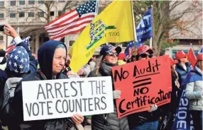  ?? JEFF KOWALSKY/AFP VIA GETTY IMAGES ?? People gather at the state Capitol for a “Stop the Steal” rally in support of President Donald Trump in Lansing, Mich.