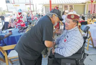  ?? Kin Man Hui / Staff photograph­er ?? Vietnam veterans Fernando Herrera, left, and Armando Albarran greet each other as vets are honored at the third annual You Are Not Forgotten event on the West Side on Saturday.