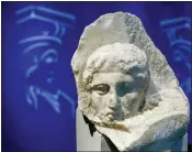  ?? THANASSIS STAVRAKIS, FILE - THE ASSOCIATED PRESS ?? The marble head of a young man, a tiny fragment from the 2,500-year-old sculptured decoration of the Parthenon Temple on the ancient Acropolis, is displayed during a presentati­on to the press at the new Acropolis Museum in Athens, in 2008.