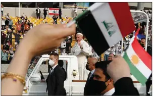  ?? (AP/Hadi Mizban) ?? Pope Francis waves to the faithful Sunday as he arrives for an open-air Mass at a stadium in Irbil, Iraq. More photos at arkansason­line.com/38francis/.