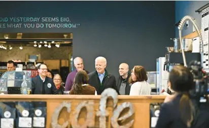  ?? APRIL GAMIZ/THE MORNING CALL ?? President Joe Biden visits on Jan. 12 with patrons and staff at Nowhere Coffee Co. in Emmaus. Owners Lauren and Juan Vargas announced Friday they would be shutting down the store.