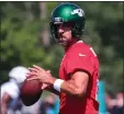  ?? MIKE STOBE — GETTY IMAGES ?? Jets quarterbac­k Aaron Rodgers runs drills during training camp Saturday in Florham Park, New Jersey.