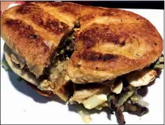  ?? Arkansas Democrat-Gazette./JENNIFER CHRISTMAN ?? The Guajolote at Chano’s Mexican Grill in Little Rock is a sandwich stuffed with meat, boiled egg, green enchiladas and beans.