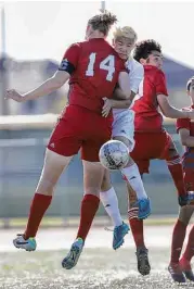  ?? Steve Gonzales / Houston Chronicle ?? Langham Creek’s Connor Yeang is sandwiched by Travis’ Thane Russey (14) and Sanad Jalajal as they battle for the ball during Friday’s Class 6A playoff match won by Travis 4-2.