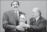  ?? AP/MICHAEL PROBST ?? Sheikh Hamad bin Khalifa Al-Thani, Emir of Qatar, (left) receives the World Cup trophy from former FIFA President Joseph Blatter after finding out that Qatar would host the 2022 World Cup in this Dec. 2, 2010, file photo. A report from former FIFA...