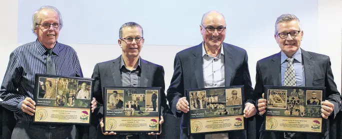  ?? GRANT HARRISON • SPECIAL TO THE GUARDIAN ?? Dave Holland, left, Robert Campbell, Harry Poulton and Peter Gallant pose with their P.E.I Sports Hall of Fame award plaques they received in an induction ceremony in Charlottet­own Nov. 25. The plaques will be on display at the P.E.I. Sports Hall of Fame in Summerside.